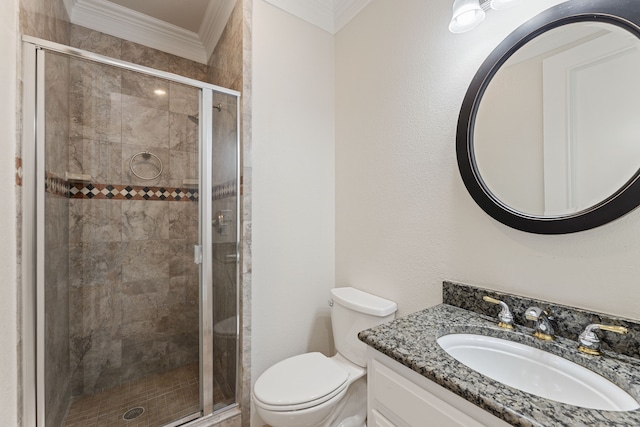 bathroom featuring toilet, a shower stall, vanity, and crown molding