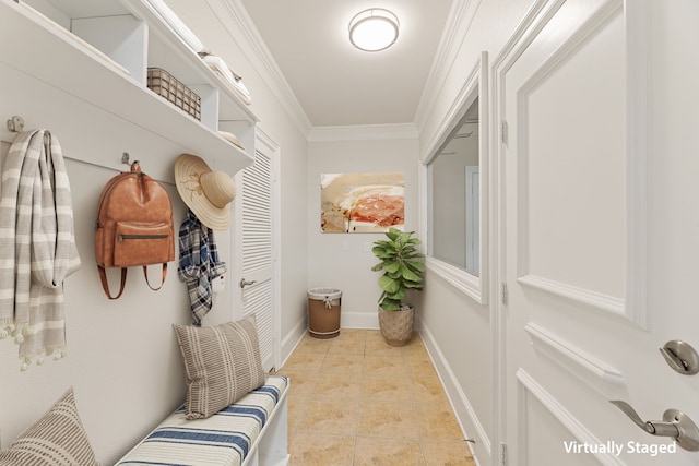 mudroom featuring ornamental molding, light tile patterned flooring, and baseboards