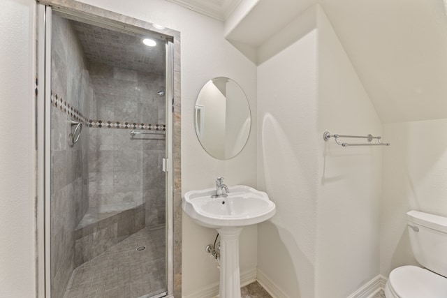 bathroom featuring a shower stall, toilet, and baseboards