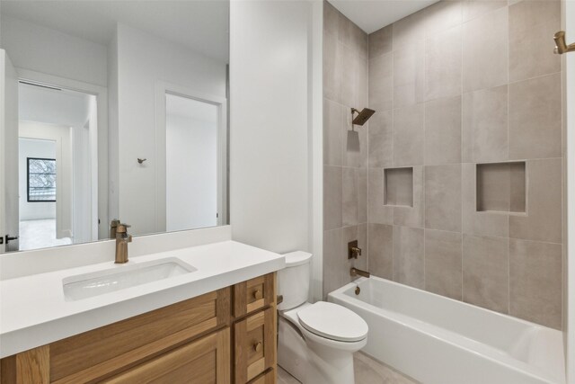 bathroom with shower / washtub combination, vanity, and toilet