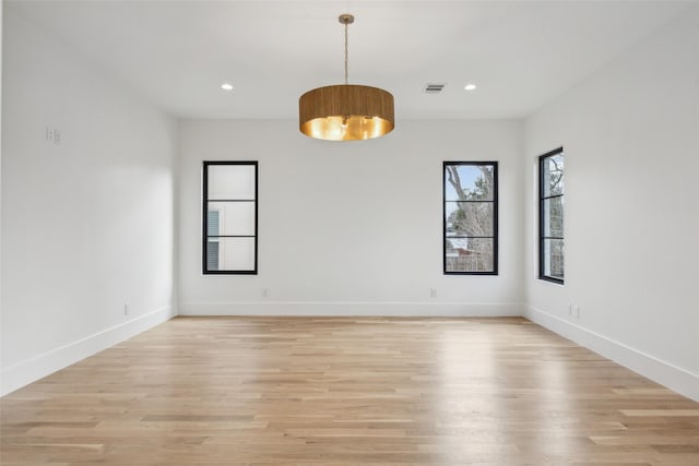 spare room with light wood-style floors, baseboards, visible vents, and recessed lighting