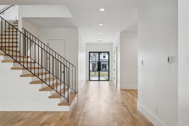 foyer entrance with recessed lighting, stairway, baseboards, and wood finished floors