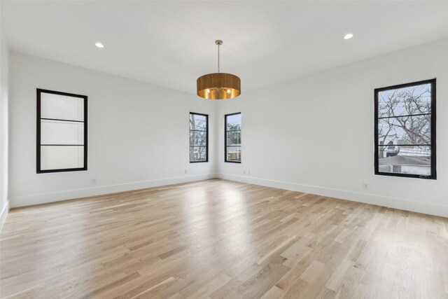 unfurnished room with light wood-style floors, baseboards, and recessed lighting