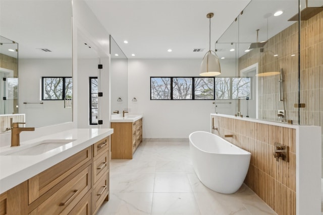 full bath with visible vents, a sink, marble finish floor, a walk in shower, and two vanities