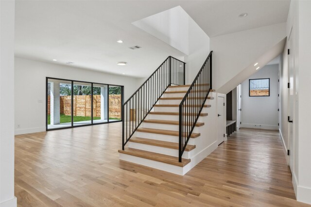 stairway featuring baseboards, wood finished floors, visible vents, and recessed lighting