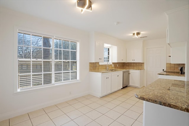 kitchen featuring stone countertops, light tile patterned flooring, and decorative backsplash