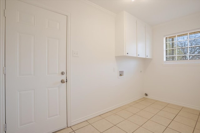 washroom featuring cabinet space, light tile patterned floors, baseboards, hookup for a washing machine, and hookup for an electric dryer