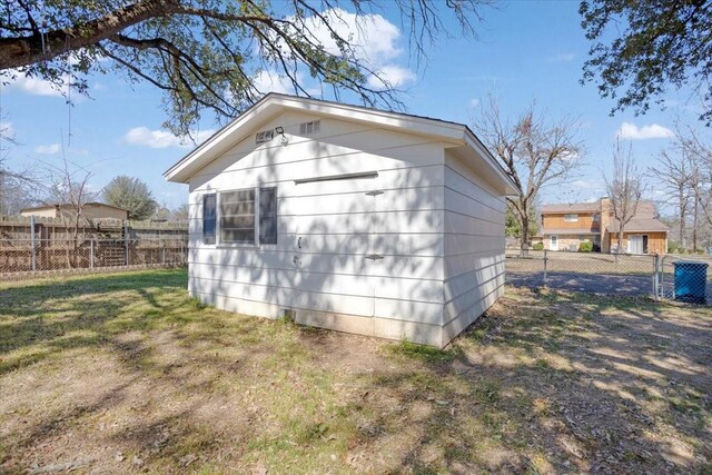 view of outbuilding featuring fence