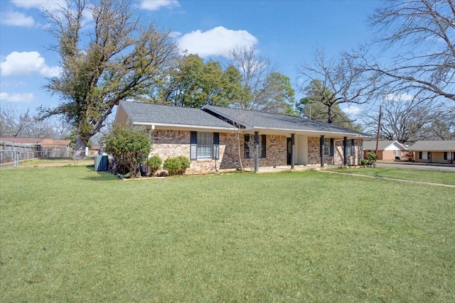 ranch-style house with fence, a front lawn, and brick siding