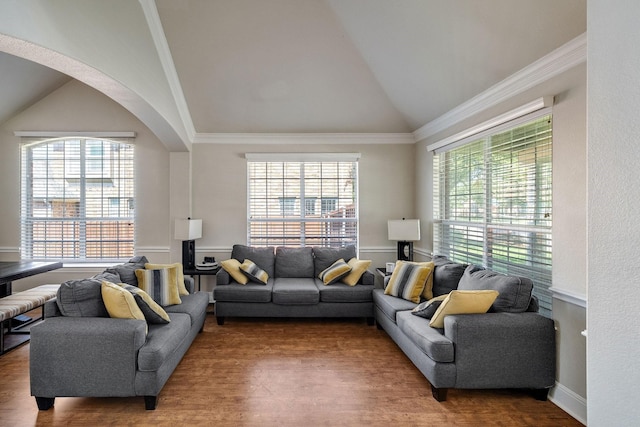 living room with ornamental molding, arched walkways, high vaulted ceiling, and wood finished floors