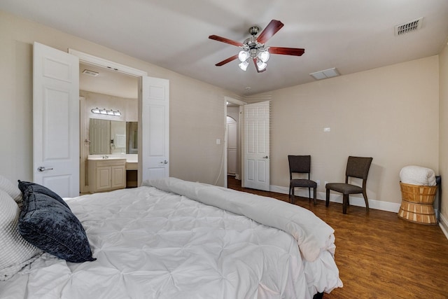 bedroom with baseboards, visible vents, and wood finished floors