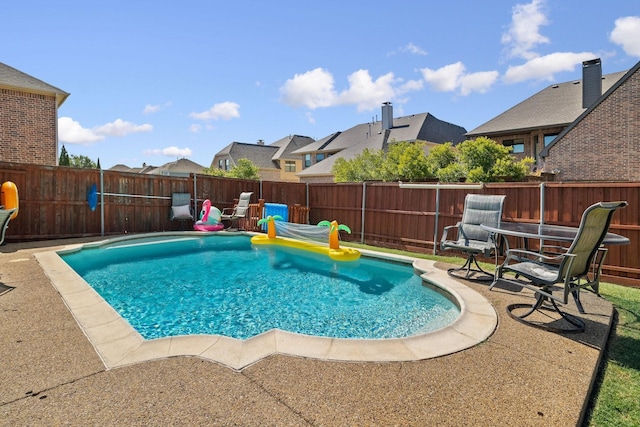 view of swimming pool with a patio area, a fenced backyard, and a fenced in pool