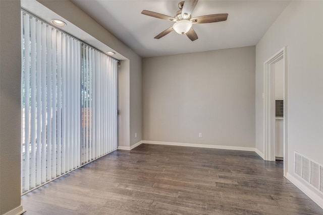 unfurnished room featuring a ceiling fan, baseboards, visible vents, and wood finished floors