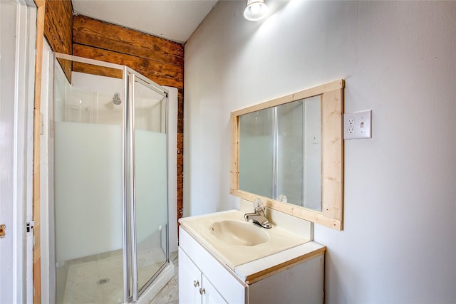 full bathroom with a shower stall and vanity