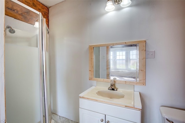 full bathroom with a stall shower, vanity, and toilet