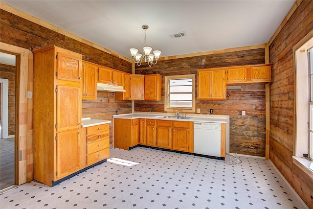 kitchen with visible vents, dishwasher, an inviting chandelier, under cabinet range hood, and a sink