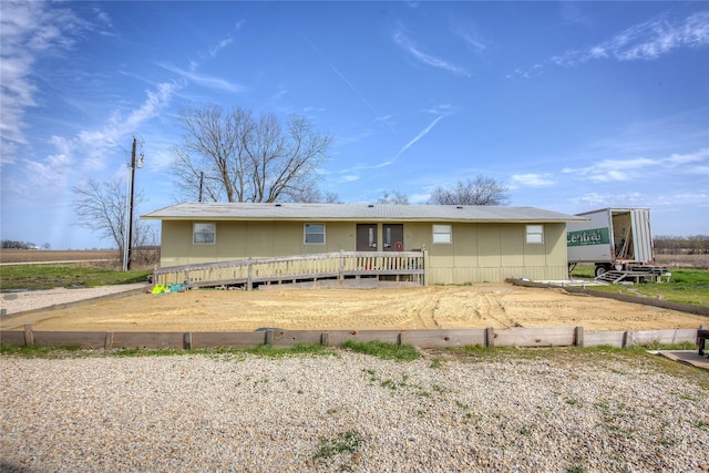 ranch-style home featuring a wooden deck