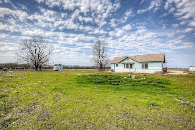 view of yard with a storage shed and an outdoor structure