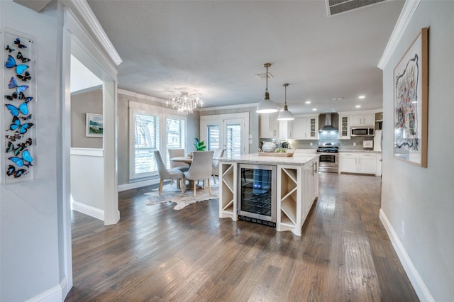 kitchen featuring wine cooler, ornamental molding, appliances with stainless steel finishes, wall chimney range hood, and open shelves