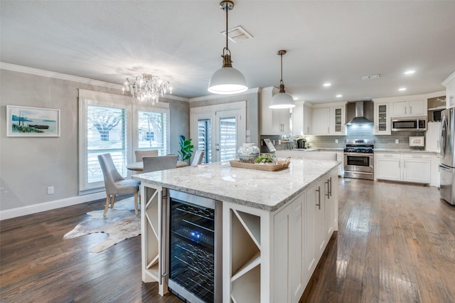 kitchen with beverage cooler, visible vents, wall chimney exhaust hood, appliances with stainless steel finishes, and open shelves