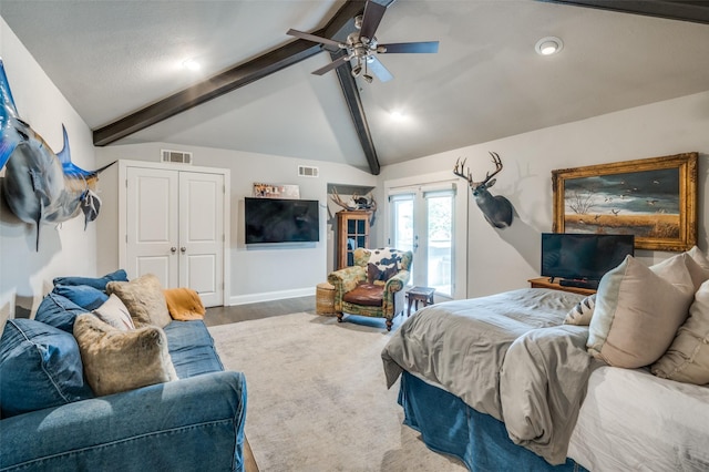 bedroom with lofted ceiling with beams, wood finished floors, visible vents, and a ceiling fan