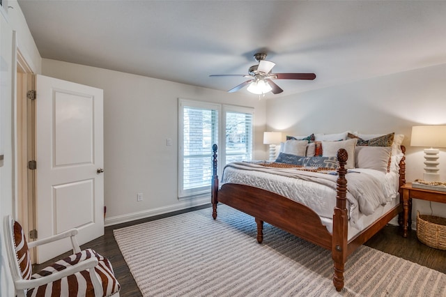 bedroom with ceiling fan, wood finished floors, and baseboards