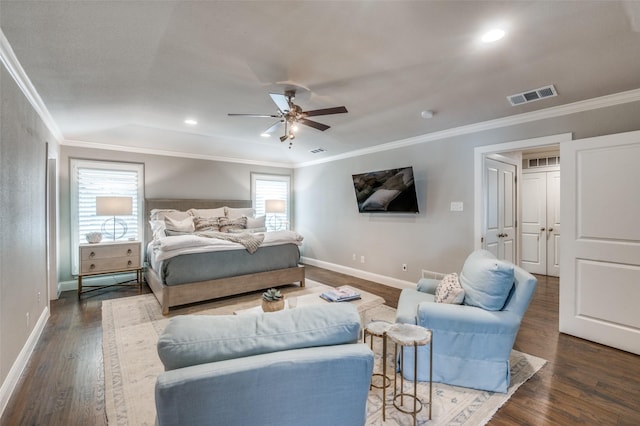 bedroom featuring ceiling fan, dark wood-type flooring, visible vents, baseboards, and ornamental molding