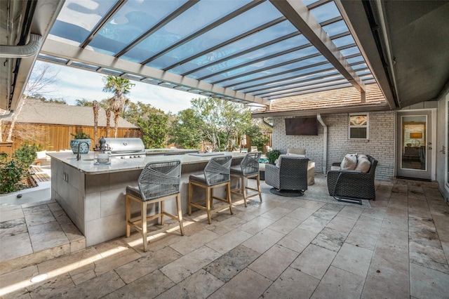 view of patio with an outdoor kitchen, area for grilling, fence, outdoor wet bar, and a pergola