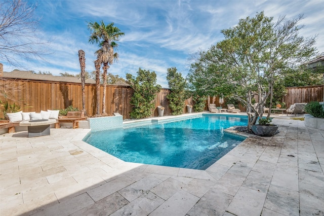 view of swimming pool featuring a fenced in pool, a patio area, a fenced backyard, and an outdoor hangout area