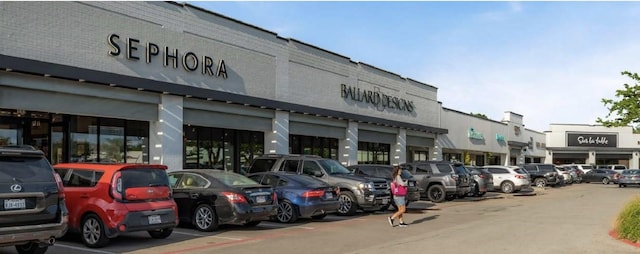 view of building exterior featuring uncovered parking