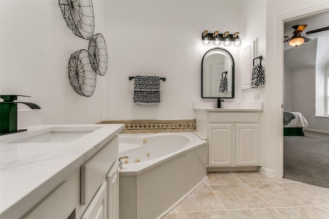 ensuite bathroom featuring ensuite bath, a tub with jets, tile patterned floors, a sink, and two vanities