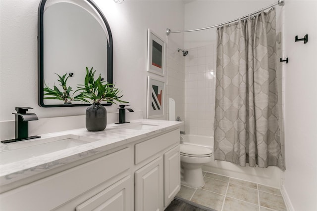 full bathroom featuring toilet, double vanity, a sink, and shower / bath combo with shower curtain