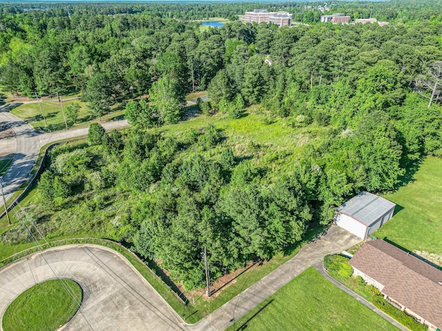 drone / aerial view with a wooded view