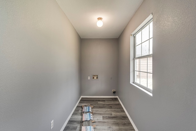 washroom with hookup for a washing machine, electric dryer hookup, wood finished floors, laundry area, and baseboards