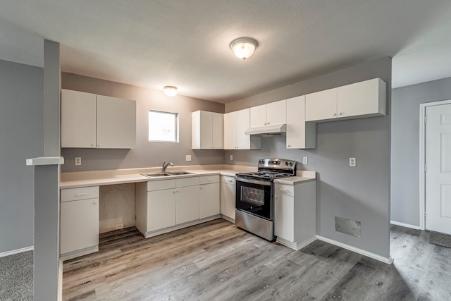 kitchen with stainless steel electric range oven, light countertops, light wood-style flooring, a sink, and under cabinet range hood