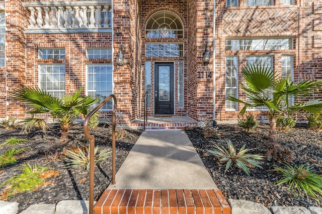 entrance to property featuring brick siding