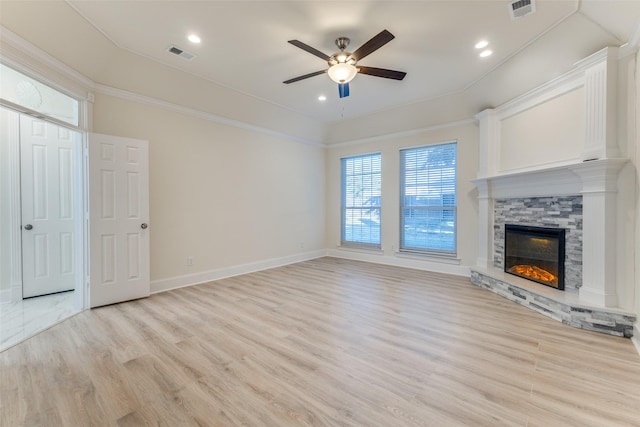 unfurnished living room with light wood-style floors, baseboards, a fireplace, and visible vents