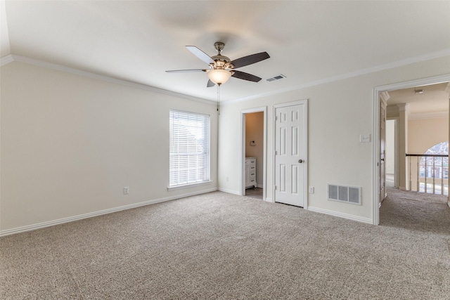 unfurnished bedroom with ornamental molding, carpet, and visible vents