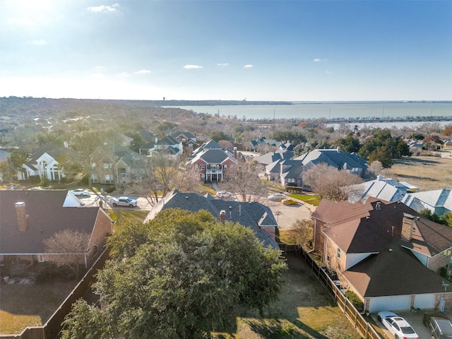 drone / aerial view with a water view and a residential view