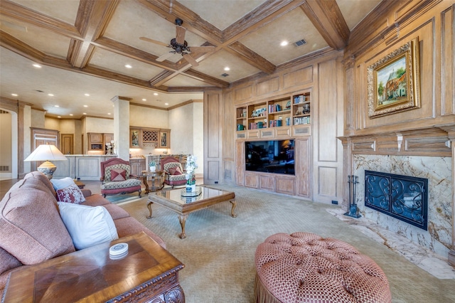 carpeted living room featuring built in features, a ceiling fan, coffered ceiling, recessed lighting, and beamed ceiling