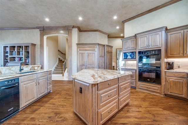 kitchen with a sink, a kitchen island, wood finished floors, and dobule oven black