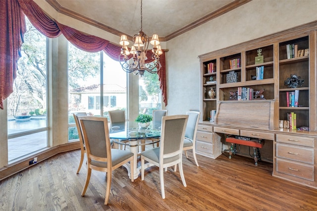 dining area featuring an inviting chandelier, wood finished floors, and ornamental molding