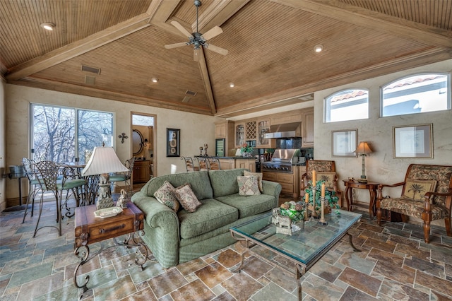 living room with wooden ceiling, stone tile floors, a ceiling fan, and visible vents