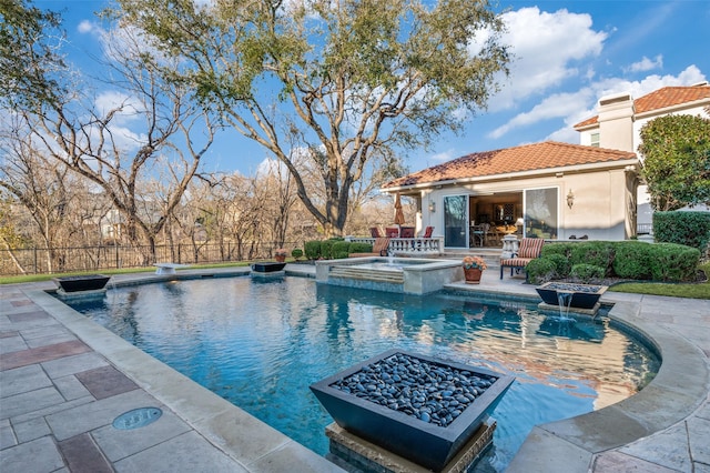 view of pool with a pool with connected hot tub, a patio, fence, an exterior structure, and an outdoor structure