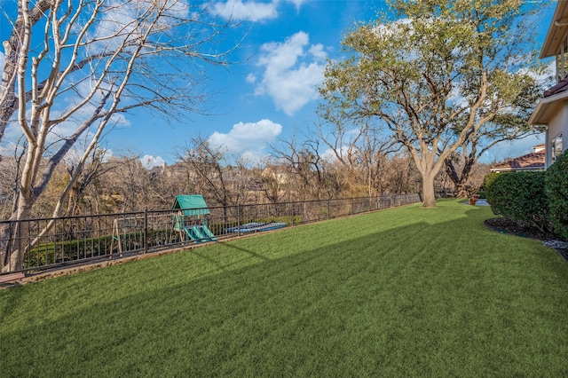 view of yard featuring a playground and fence