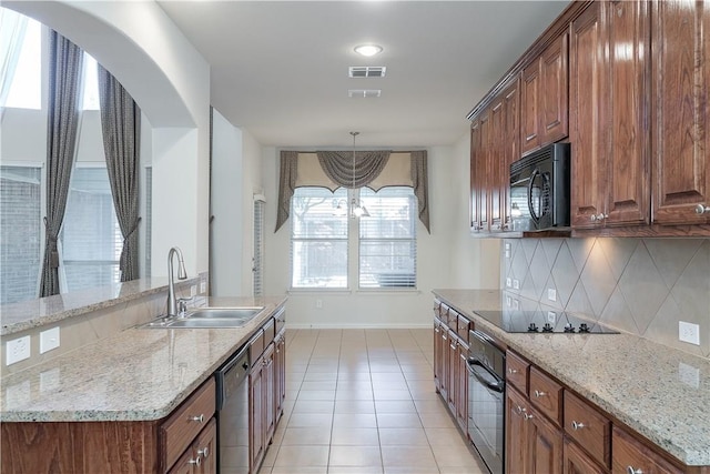 kitchen with light tile patterned floors, visible vents, backsplash, a sink, and black appliances