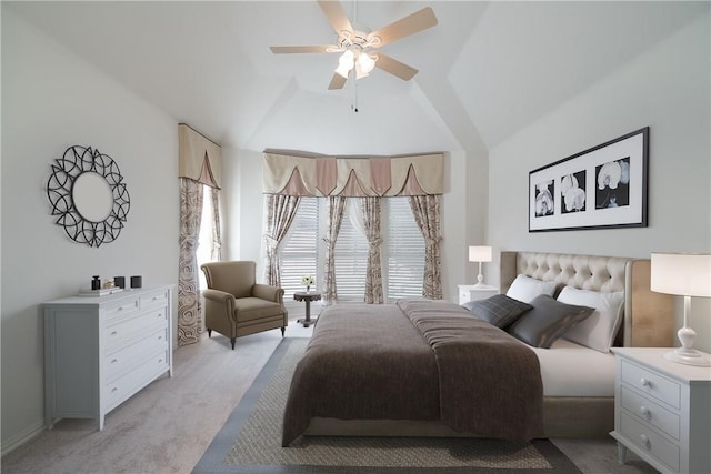 bedroom featuring light carpet, lofted ceiling, and a ceiling fan