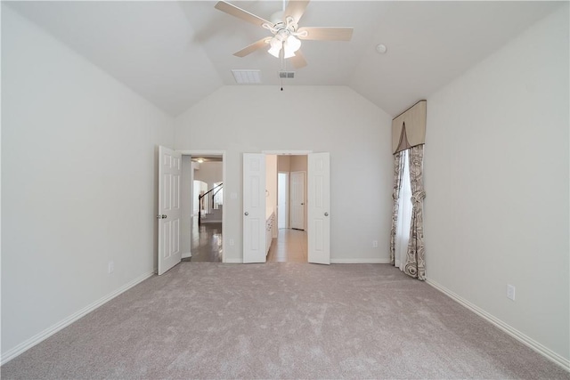 unfurnished bedroom with light carpet, baseboards, visible vents, and vaulted ceiling