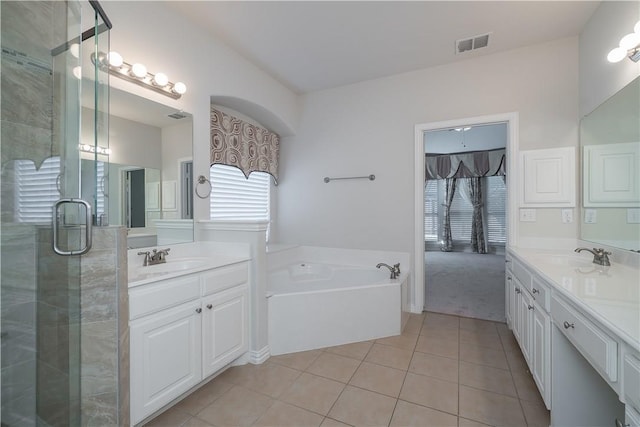 bathroom with two vanities, tile patterned flooring, visible vents, and a sink