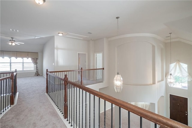 hall with carpet, visible vents, lofted ceiling, and an upstairs landing